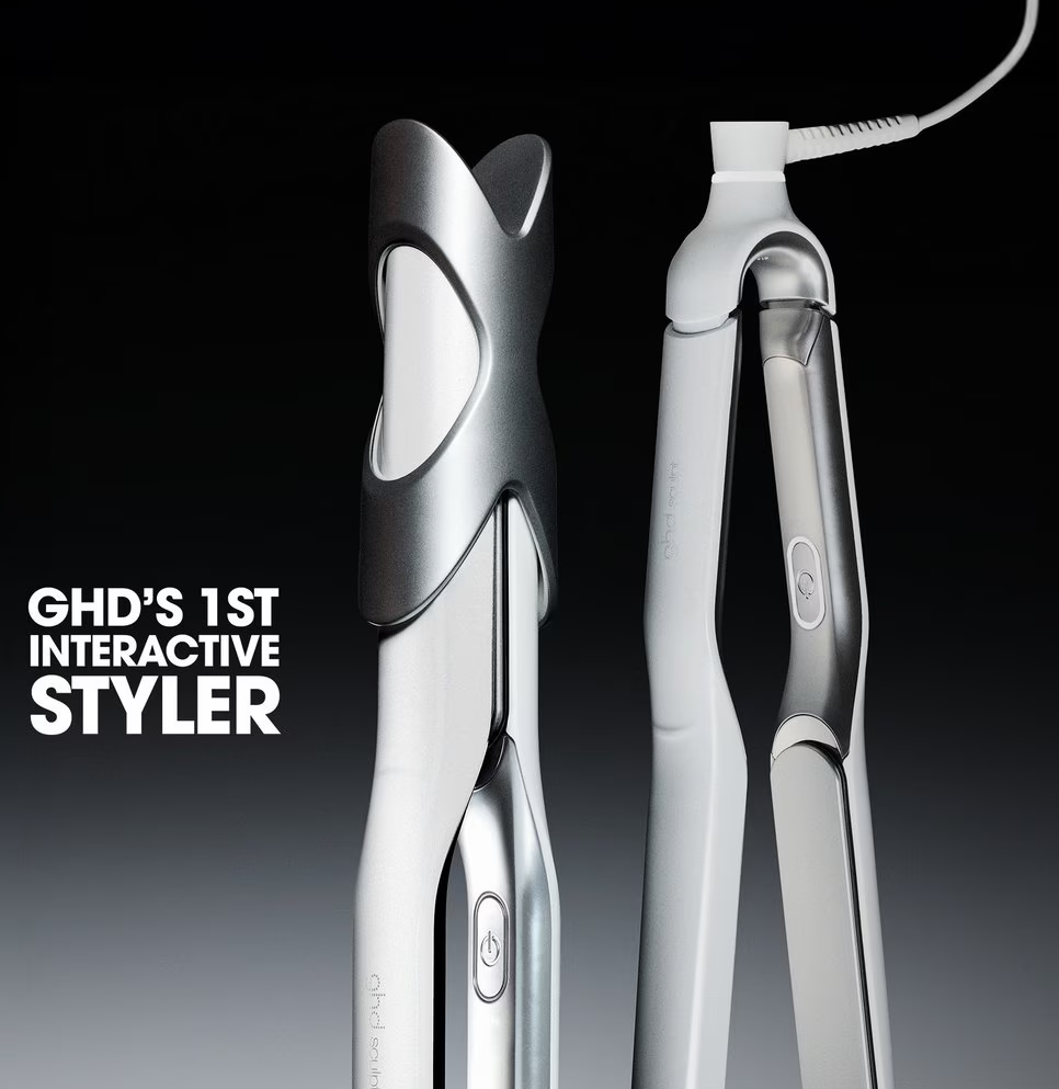 Matte black ghd Sculpt interactive hair styler laying flat on a neutral background showing its slim barrel and waterfall plates.